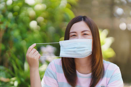 Thai women wearing masks with natural blur background. Concept for disease prevention.の写真素材