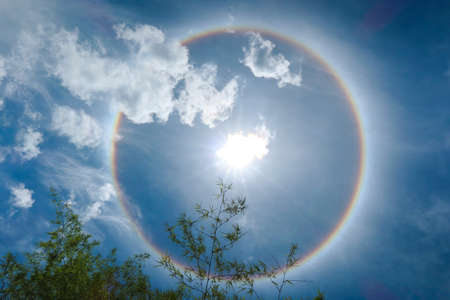 Sun halo is a natural phenomenon that looks like a reflection of many suns overlapping larger than usual. There was a rainbow aura surrounding it. The one in the middle is the brightest.の写真素材