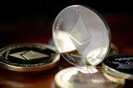 Maesot, Thailand- June 13, 2021:Close-up Ethereum coins stacked on a wooden table. Concept crypto...