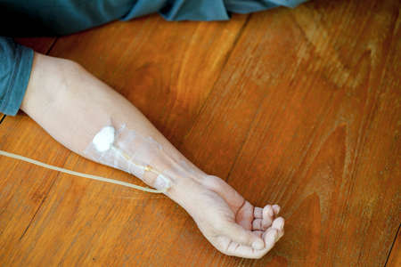 Arm of a male patient who was injecting saline solution into veins.の写真素材