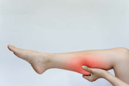 A woman's calf pain may be caused by an injury that causes muscle inflammation or some chronic disease.の写真素材