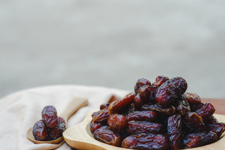 The dates in the wooden cups on the table were sweet, but lowered blood sugar. It is a fruit that Muslims like to eat during the month of Ramadan.の写真素材