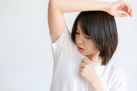 Woman raising her arms because of sweating under armpits.の写真素材