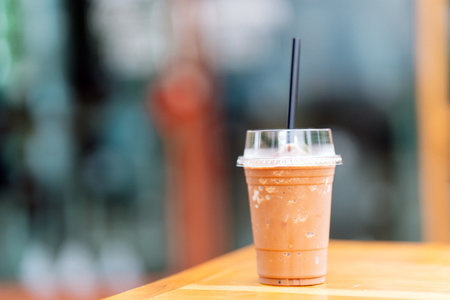 Cocoa juice in plastic glasses with straws on the table. Copy space.の写真素材
