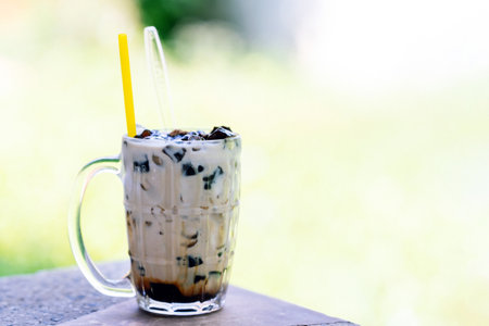 Fresh milk grass jelly in a glass on the dining table.の写真素材