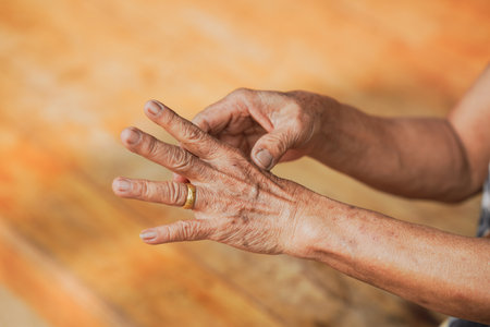 Close-up view of elderly hands demonstrating gestures, showcasing the intricate details of skin and veins, symbolizing life experiences and wisdom.の写真素材