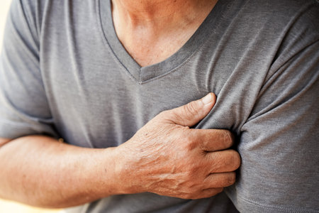 person in gray shirt is clutching their chest, possibly indicating discomfort or pain. image...