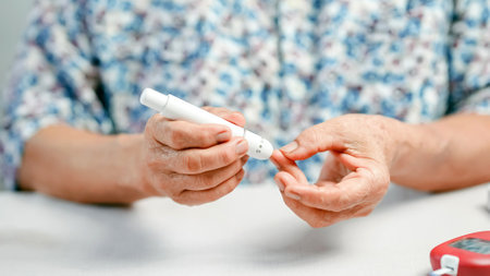 An elderly person hand blood glucose test diabetes healthcare monitoring finger prick medical device...