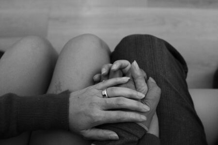 Asian woman and man holding hands with rings in black and white.の写真素材
