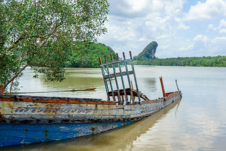 Shipwreck in the river near mangrove forest in Krabi, Thailand.の写真素材