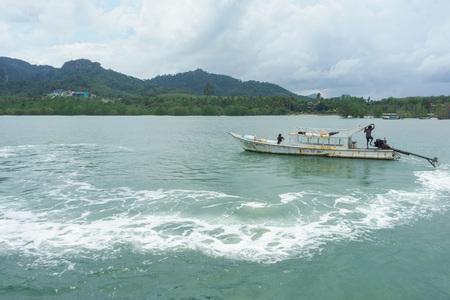 Krabi, Thailand - August 6, 2016: Old boat in the sea at Ao Nammao pier in Krabi, Thailand.のeditorial素材