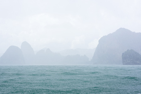 Blur background of raindrops, sea waves and mountains.の写真素材