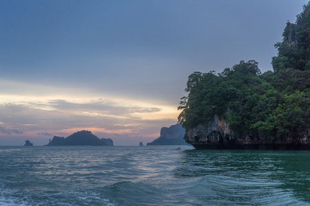 Twilight sky and sunset in Krabi with rocky cliff and islands.の写真素材