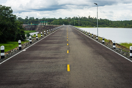 Ubonratchathani, Thailand - September 7, 2016: Asphalt road over Sirindhorn dam with hydroelectric power station in Ubonratchathani, Thailand.のeditorial素材