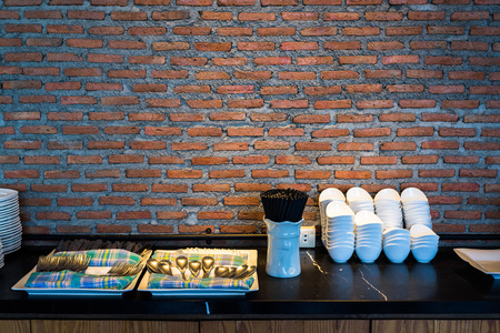 Tableware and crockery with red brick wall background in restaurant.の写真素材