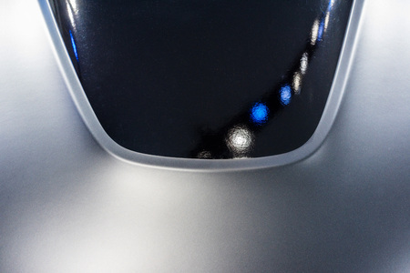 Abstract of black and gray car hood with blue and white reflectionの写真素材