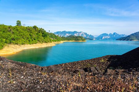 Blue lake and green forest with limestone mountain range background at Rajjaprabha dam in Suratthani, Thailand.の写真素材