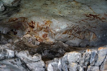 Ancient cave paintings on the limestone wall under an island in Phang Nga Bay, Thailand.
