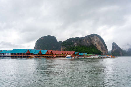 Phang Nga, Thailand - July 16, 2019: Small community and village living on the sea with houses, rafts, speed boat and tourists at Koh Panyee island in Phang Nga, Thailand.のeditorial素材