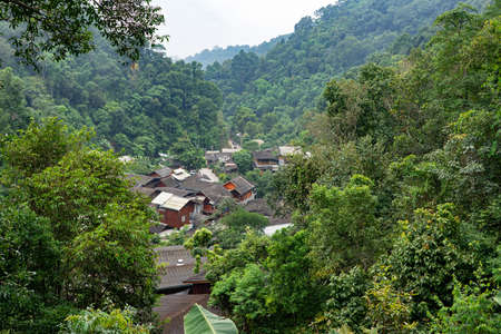 Roofs and houses in Mae Kampong village in the green valley with mountain and trees in Chiang Mai, Thailand.の写真素材
