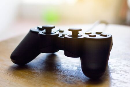 Video game controller black Joystick on wooden tableの写真素材