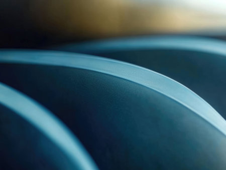 Macro view of curved turbine blades with metallic finish, smooth polished texture, and gradient lighting, highlighting advanced industrial technology and innovation.の素材