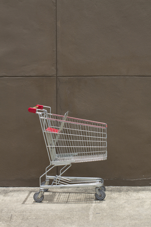 Shopping cart with brown wall backgroundの写真素材