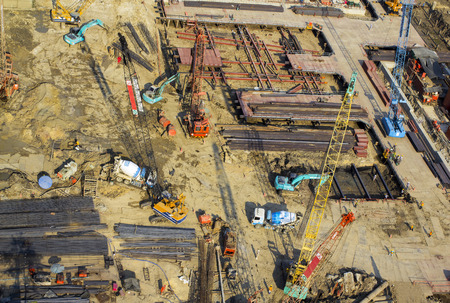 Worksite: top side view of unfinished building and tower crane isolated on whiteのeditorial素材