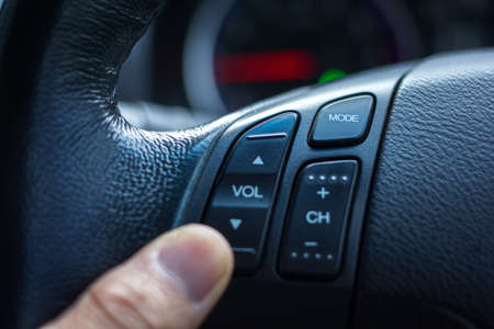 Close-up shots are changing the sound button on the steering wheel.の写真素材