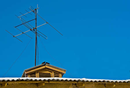 Home TV antennas mounted on a roofの写真素材