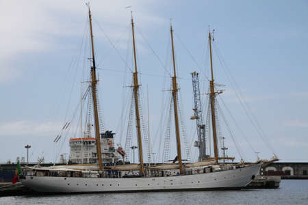 old three-masted sailing ship in the harbor wharf