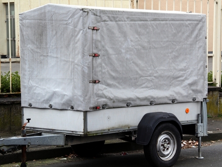 Close up of a car trailer with gray tarp