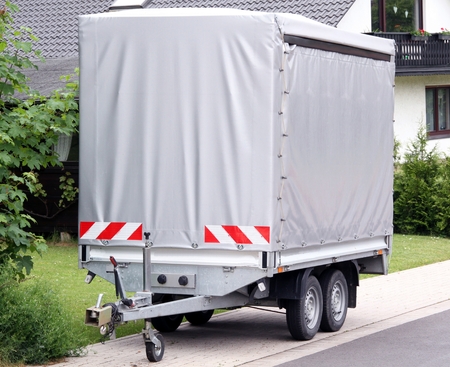 Car trailer with high gray tarp