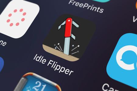 London, United Kingdom - September 29, 2018: Icon of the mobile app Idle Flipper from Voodoo on an iPhone.のeditorial素材