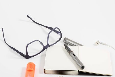 Office equipment with white background glasses pens
