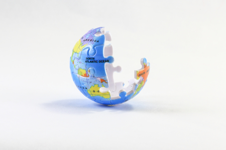 Incomplete Jigsaw puzzle pieces globe on white background