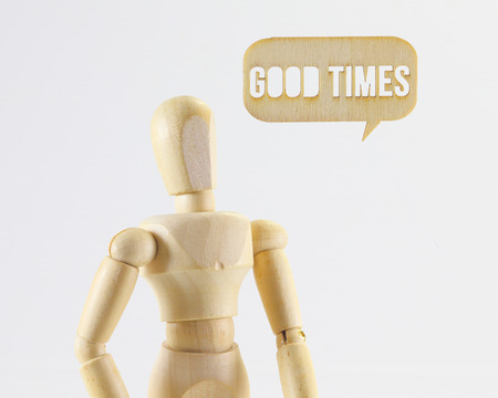 Wooden puppet figure with Good Times word sign on white backgroundの写真素材