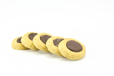 Chocolate drop cookies biscuits with chocolate topped on white backgroundの写真素材