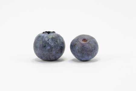 Juicy ripe dark blueberry fruit on white background