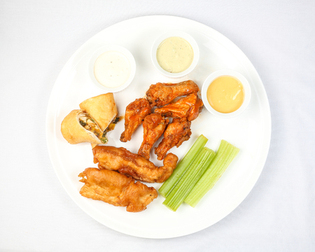 Chicken buffalo wing salary tender cheese roll appetizer platter dip sauceの写真素材