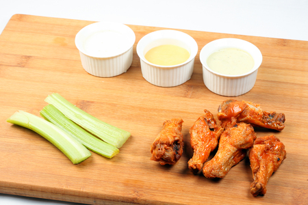 Chicken buffalo wing dip barbeque on wooden boardの写真素材