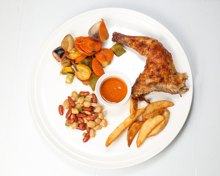Grilled Chicken Leg with potato wages bean salad grilled vegetable on white backgroundの写真素材