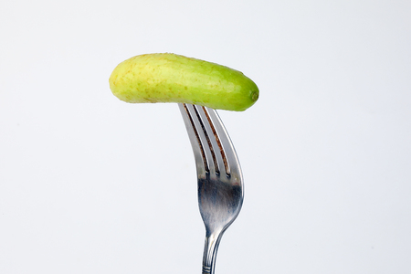 Small mini fresh green cucumber vegetable on white background の写真素材