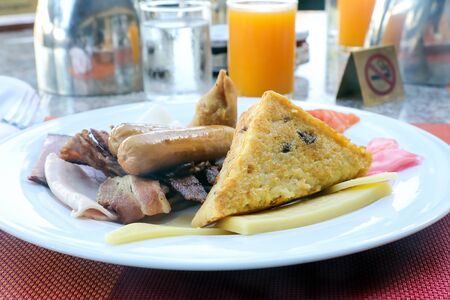 Big Breakfast outdoors toast sausage bacon eggs orange juice coffee の写真素材