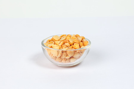 Yellow split chickpea peas boot chana dal lentil pulse bean on white background の写真素材