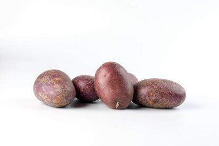 Purple color small baby potato on white backgroundの写真素材
