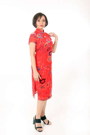 South east Asian Malay race ethnic origin woman wearing Chinese dress costume red batik print samfu...