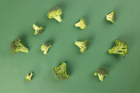 chopped sliced diced broccoli on green background