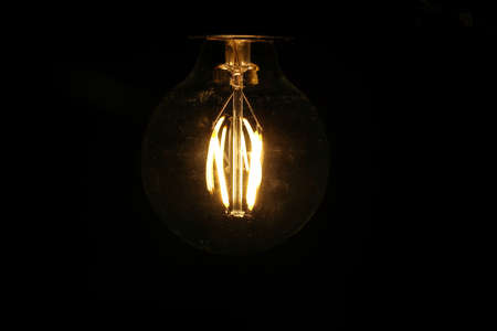 Light bulb tungsten LED on off flicker on black background