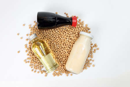 bottle of soya bean sauce oil milk bed of soyabean on white background